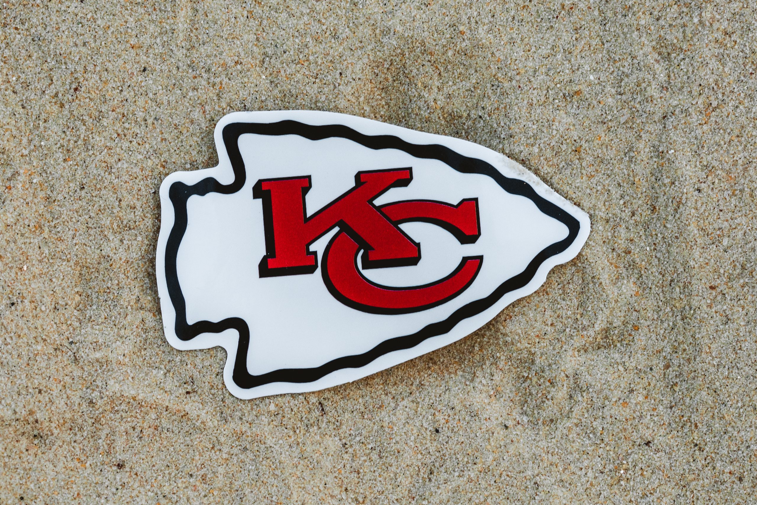 September 15, 2021, Moscow, Russia. The emblem of the Kansas City Chiefs football club on the sand of the beach.