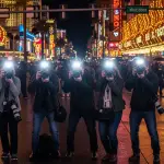 photographers lined up outside a busy las vegas street to take pictures of celebrities